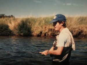 A fisherman in old rubber waders